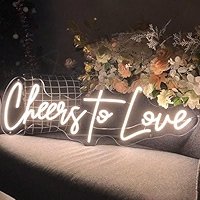 White neon light sign reading "Cheers to Love."
