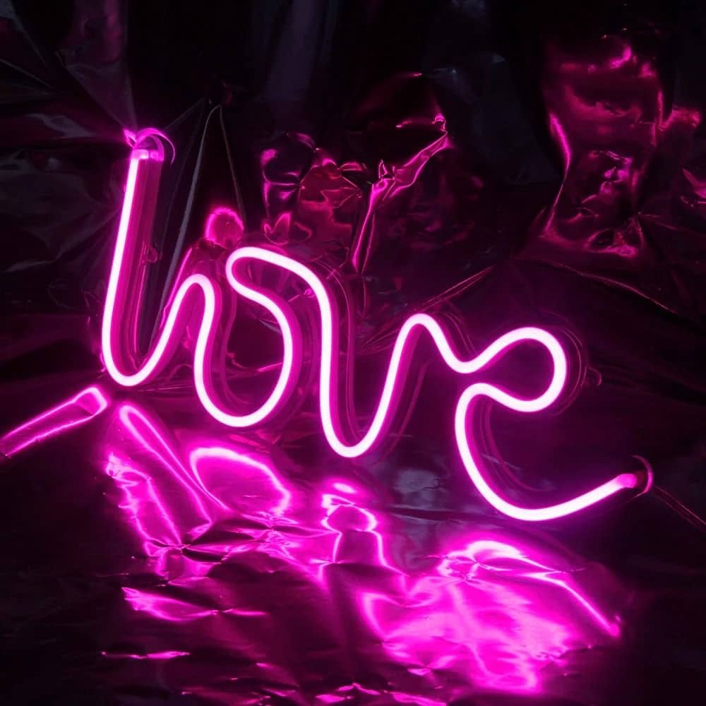 Love neon light sign in cursive font for romantic decor by Skylayers.ae