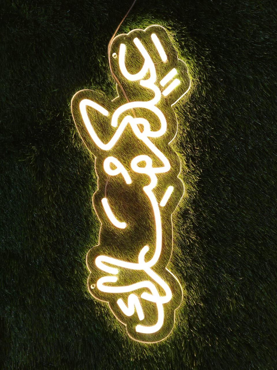 Eid Mubarak neon sign glowing in warm gold light